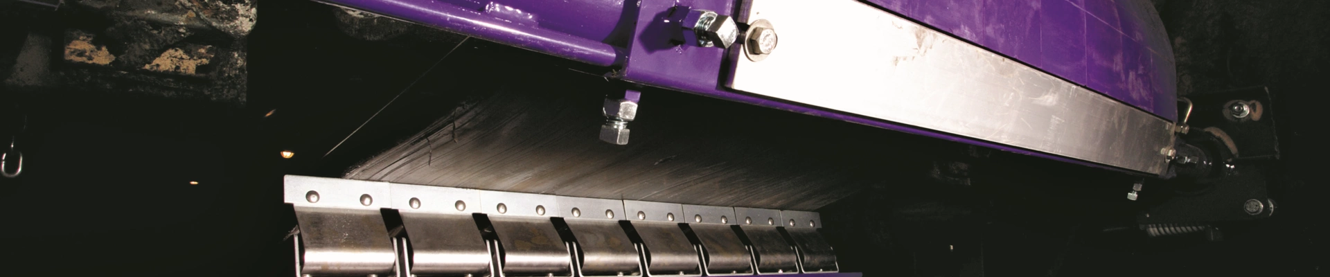 A purple Flexco belt retouch fitted to a conveyor system